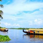 Traditional houseboat cruising through the backwaters of Kuttanad